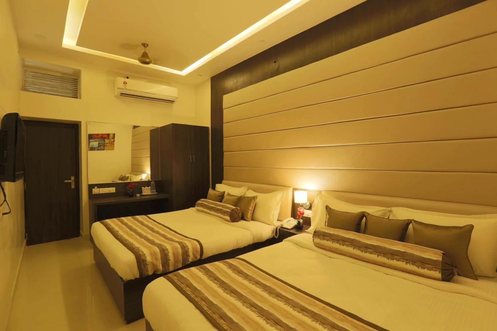 a triple bedroom with t.v at royal palace in ajmer