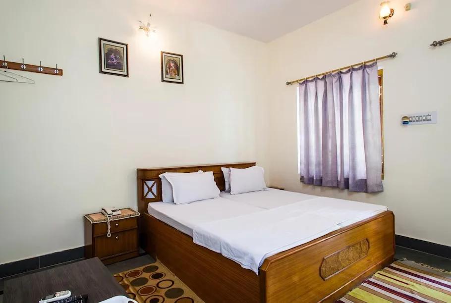 a bedroom with a window at staybook hotel vatika in Ranthambore