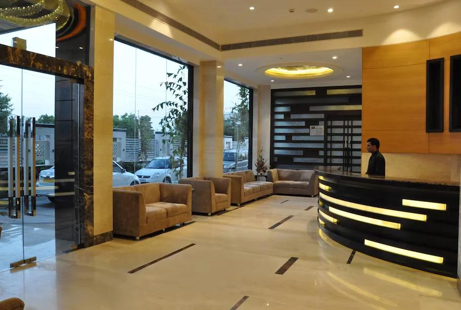 a reception area with sofa and lights at marigold hotel in jaipur