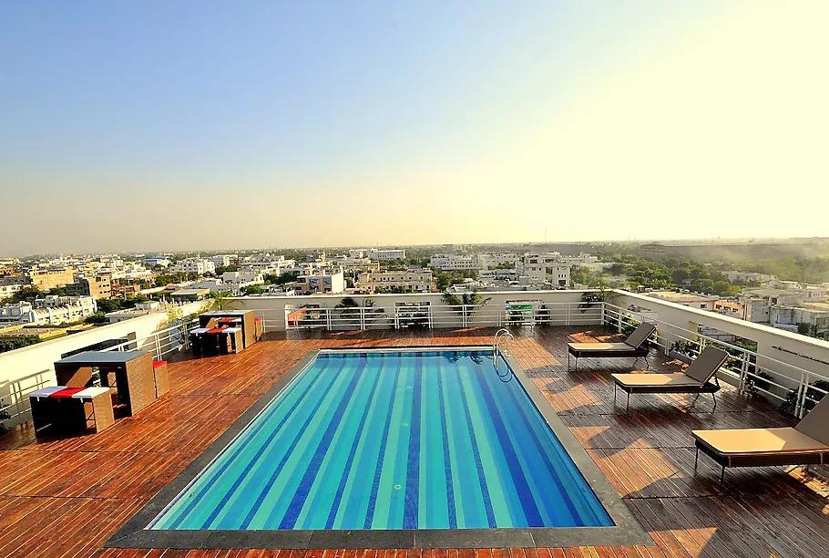 a swimming pool in the middle of building with at marigold hotel in jaipru