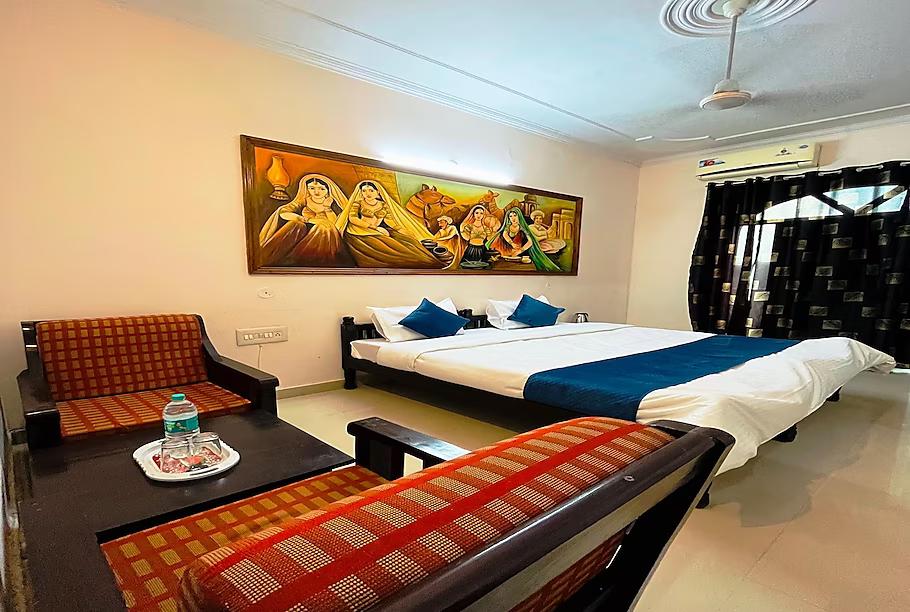 a hotel with a large bed and sofa at the ranthambhore heritage hotel in ranthambhore