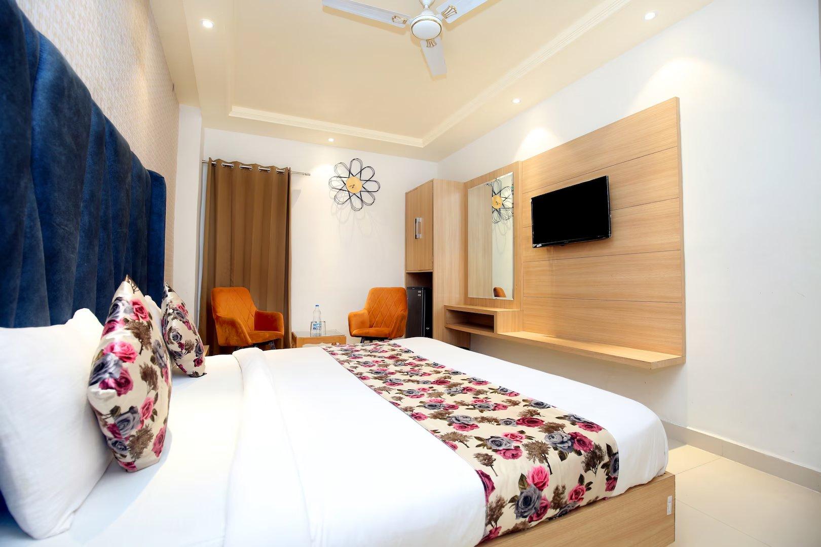 a bed room with t.v at hotel apple tree in amritsar